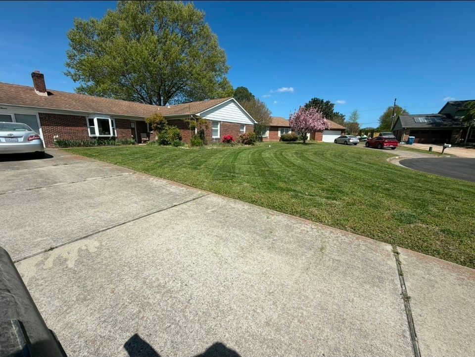 Wide angle shot of a clients front grass beautifully cut, done by Get A Mow On Lawn Care LLC of Chesapeake VA