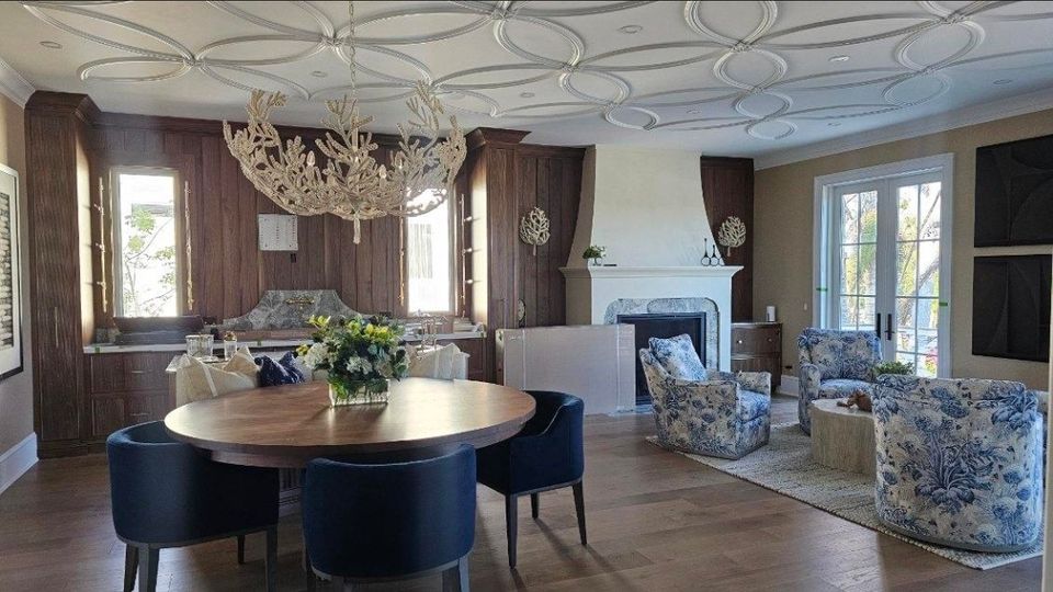 Formal dining room with decorative ceiling trim wood paneling and hardwood flooring in Chagrin Falls