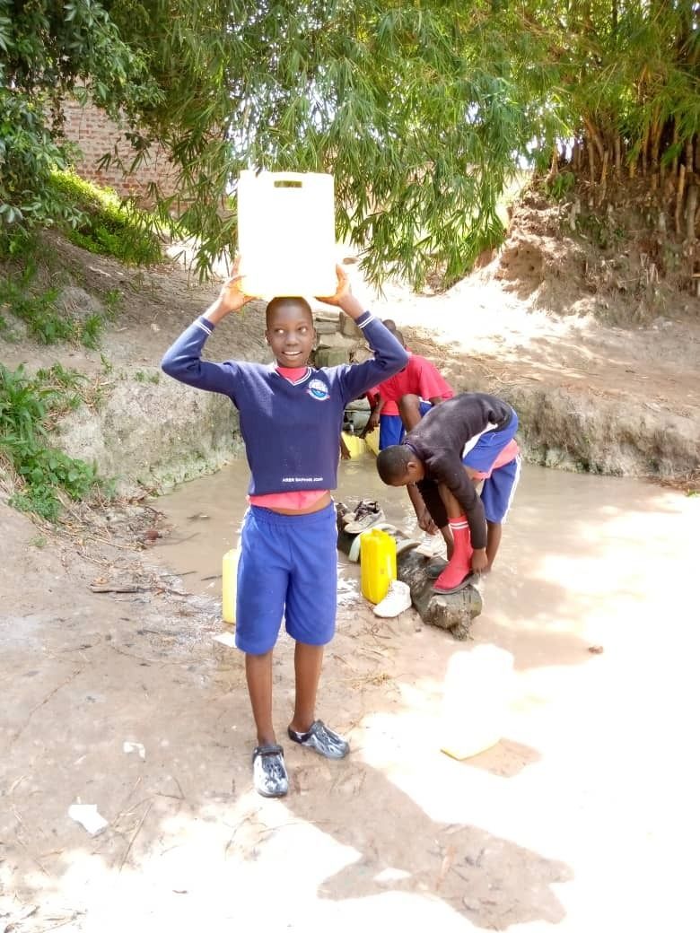 Students collecting dirty water for their families   generally it is the girls collecting but not from schools 35 