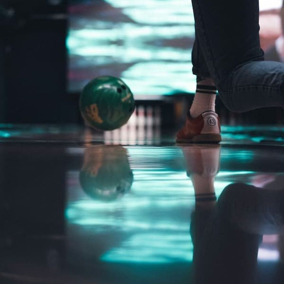 Bowling - bowling shoe, and ball with the pins in the background 