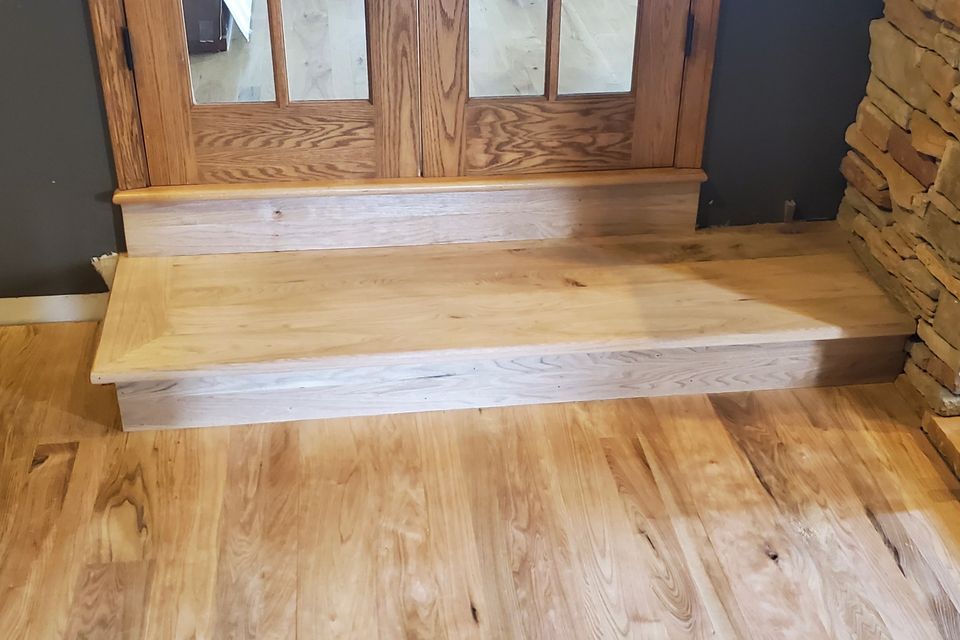 Hardwood flooring job with a matching step, done by Siti Floors of Northeast Ohio