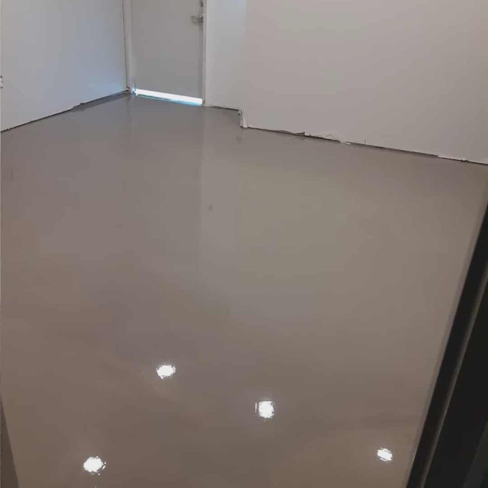 High-gloss finished concrete floor in an interior space.