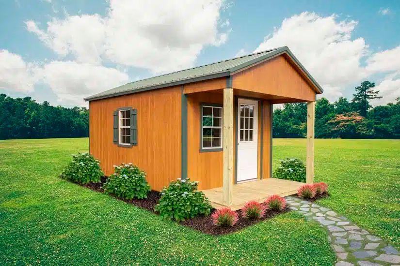 Wood tone standard cabin with covered front porch and landscaped beds in Knoxville TN