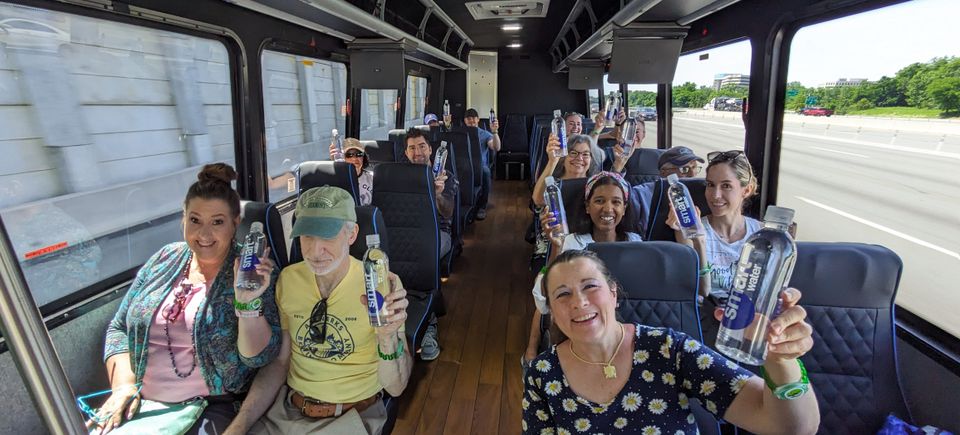 Group enjoying a vineyard tour from inside a comfortable bus