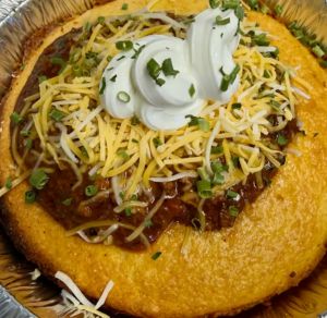 Hearty chili in warm cornbread bowl