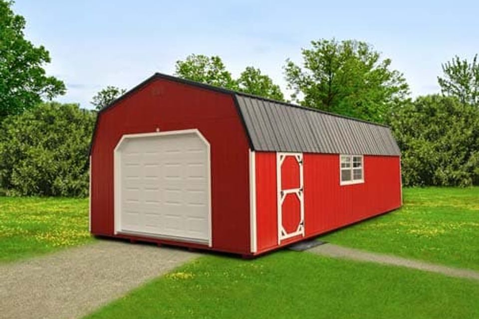 Red high wall barn garage with white overhead door and metal roof in Elizabethton TN