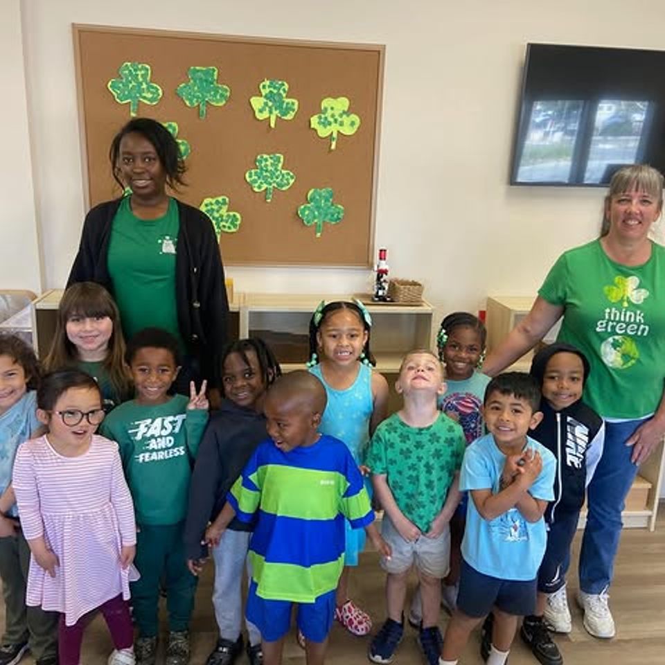 Preschool class and teachers dressed in green for a St Patrick's Day celebration at a Montessori school in Palmdale CA