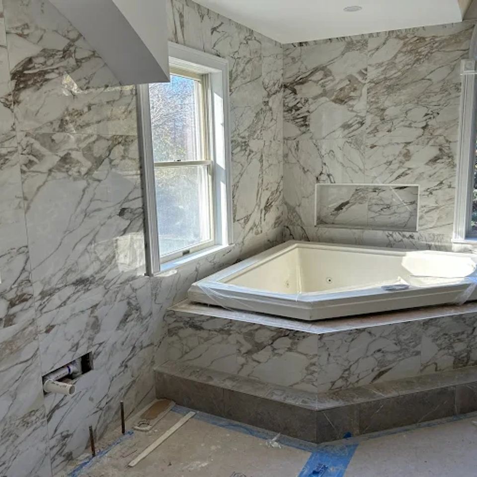 A bathroom featuring extensive use of stone-look large format tile by Taurus Contracting