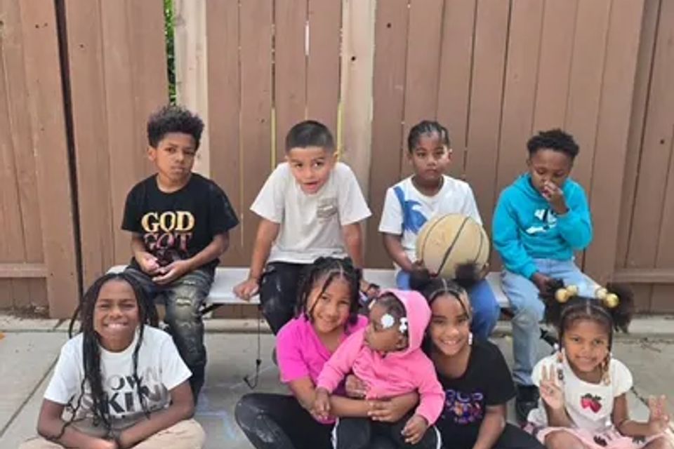 Children taking a group photo in the childcare backyard