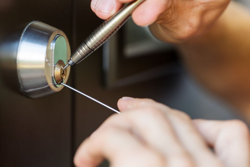 24/7 locksmith skillfully employing tools to unlock a door.
