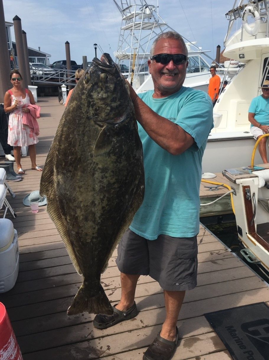 Captain stan holding huge flounder