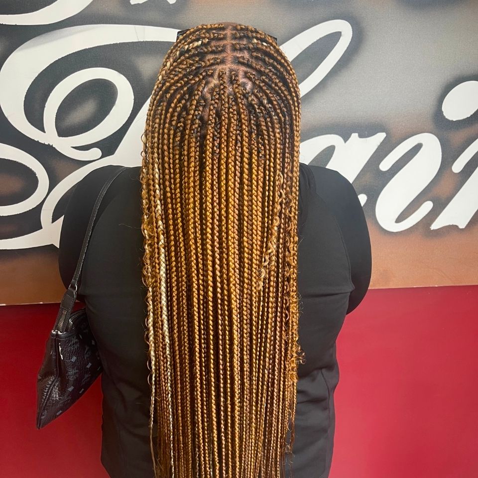 Long honey blonde knotless box braids after a braiding service in Los Angeles CA