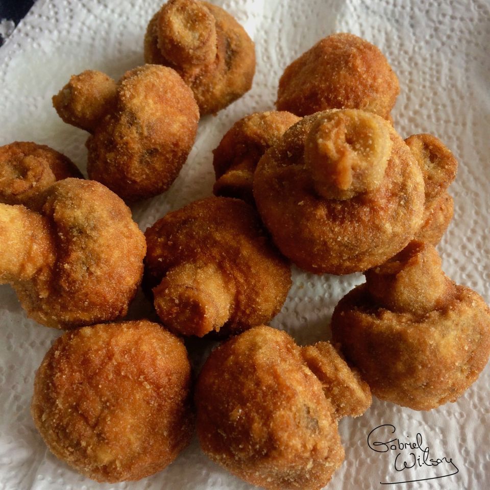 Deep fried breaded mushrooms stuffed with cream cheese served with garlic mayonnaise