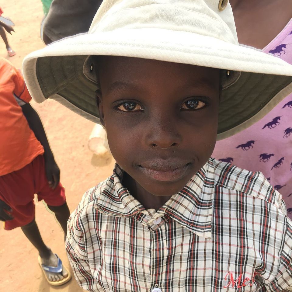 Happy ugandan child in a hat