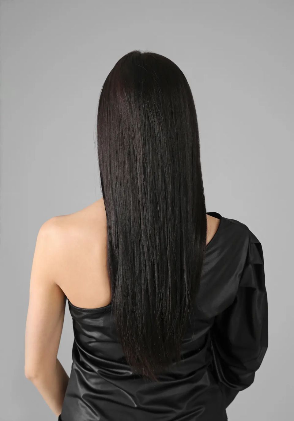 Woman with beautiful healthy straight hair on grey background