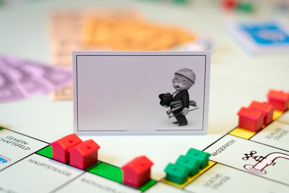 The Mortgage Krew - Navigating the Real Estate Game: Monopoly board with 'Finding Property is Here' caption.