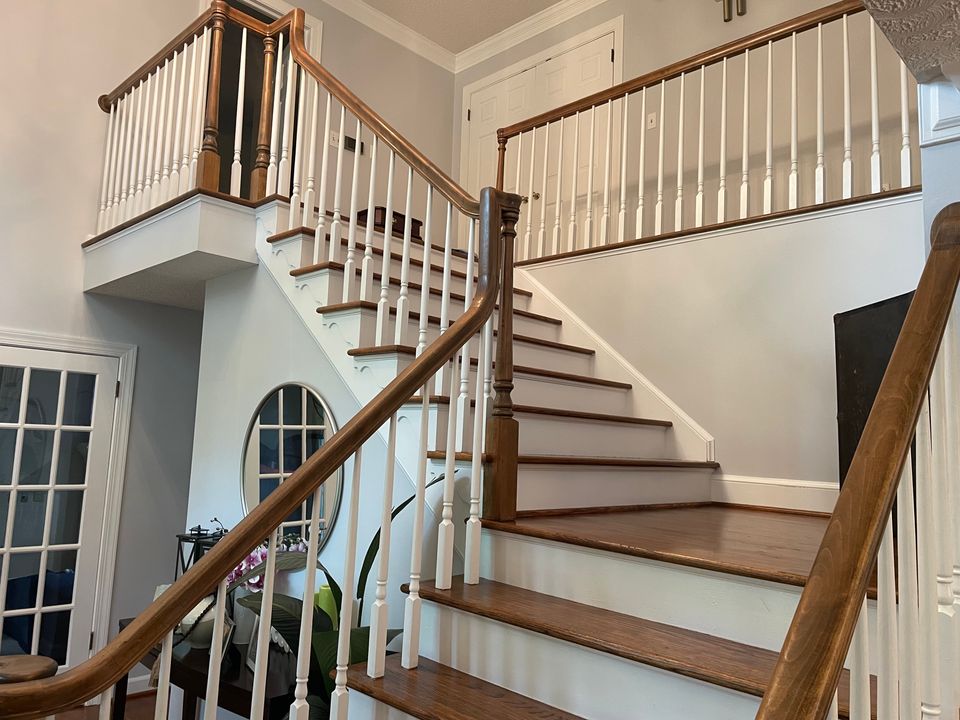 Clean hardwood staircase with polished wood railings after a house cleaning service in Virginia Beach VA
