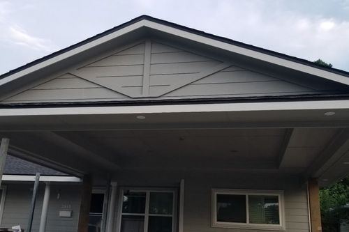 Close‑up of carport soffit with recessed lights and stone column bases in Humble, TX