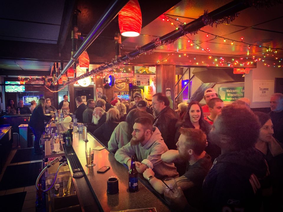 Crowd in bar watching tv