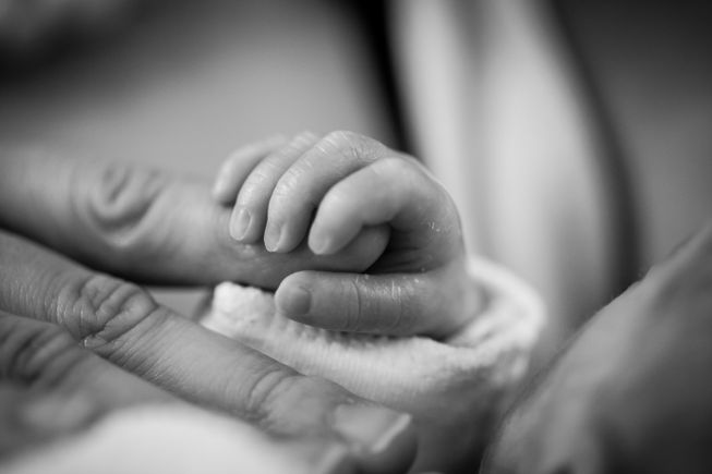 Grayscale photography of baby holding finger 208189
