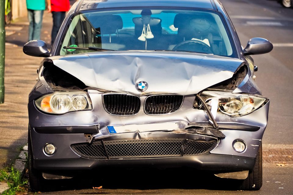 Image of a grey BMW with extensive front end damage
