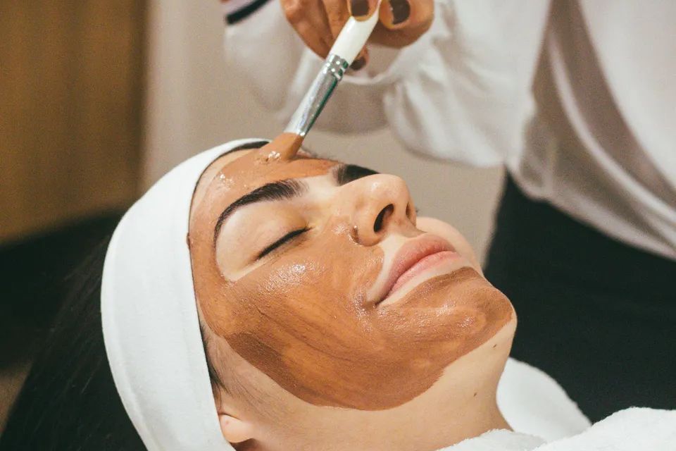 Esthetician student performing facial treatment in skincare training program