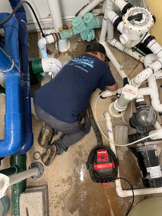 Kenny working in pool room fixing a leak