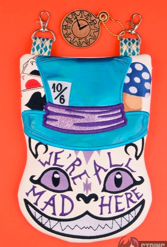 Custom embroidered zipper pouch featuring a whimsical character design with a blue top hat, clock, and decorative artwork.