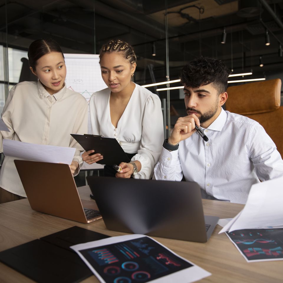 Office workers using finance graphs (1)