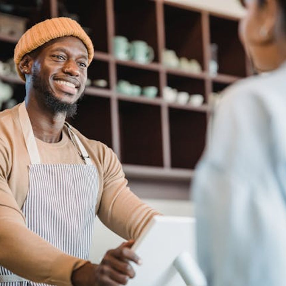 Man smiling taking an order