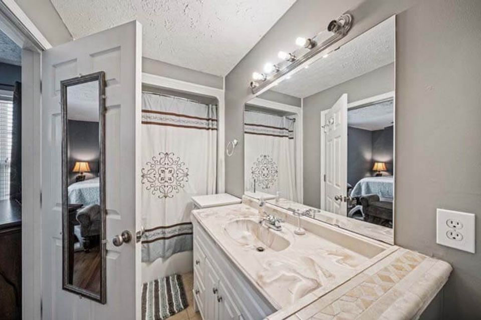 Stylish bathroom remodel with glass shower enclosure and tile flooring in Knoxville TN