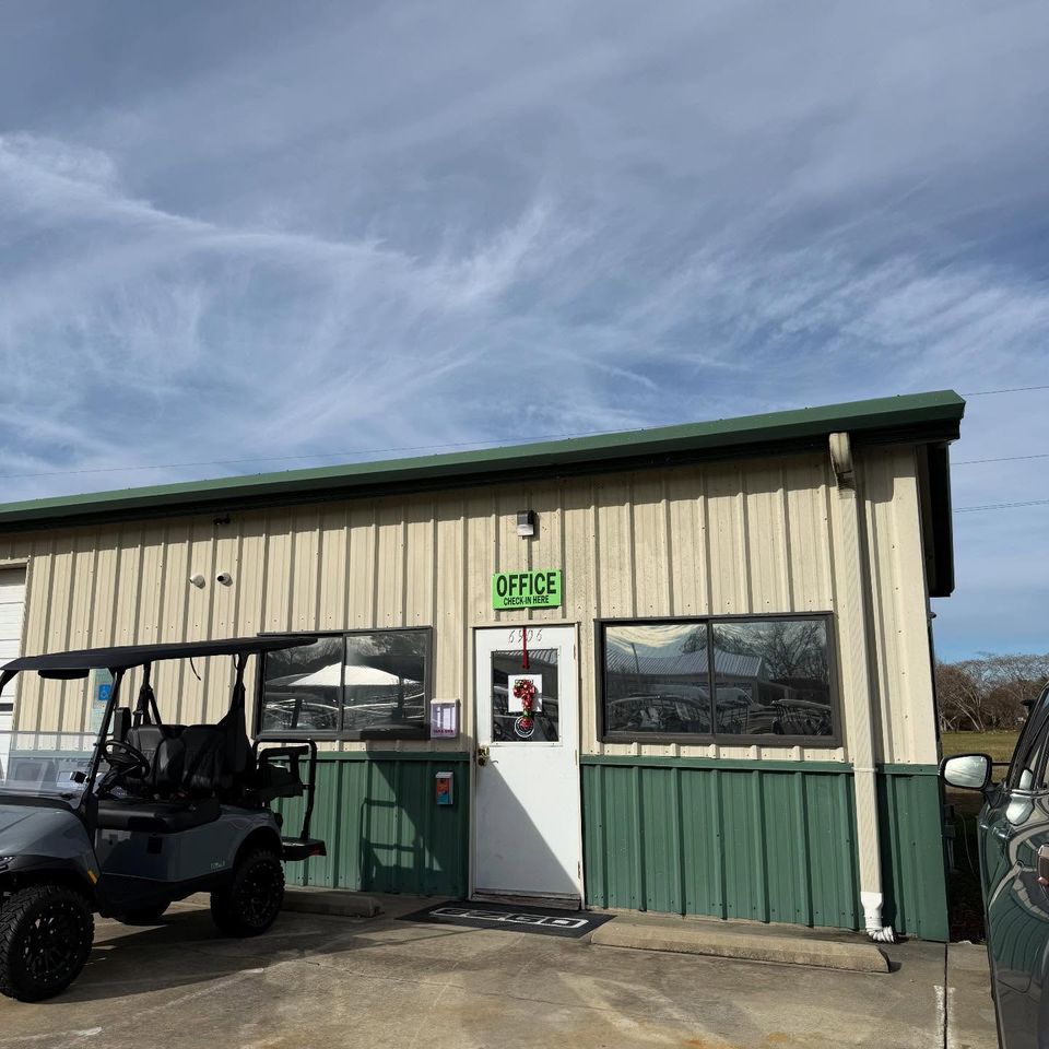 Metal office building with tinted windows and a golf cart parked outside in Moyock North Carolina