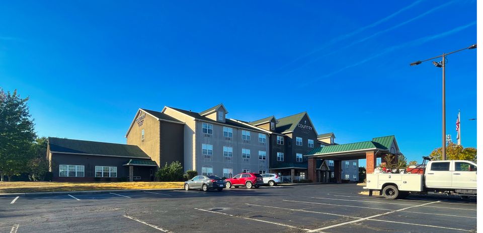 Commercial power washing for a business storefront and parking lot in Louisville, Kentucky