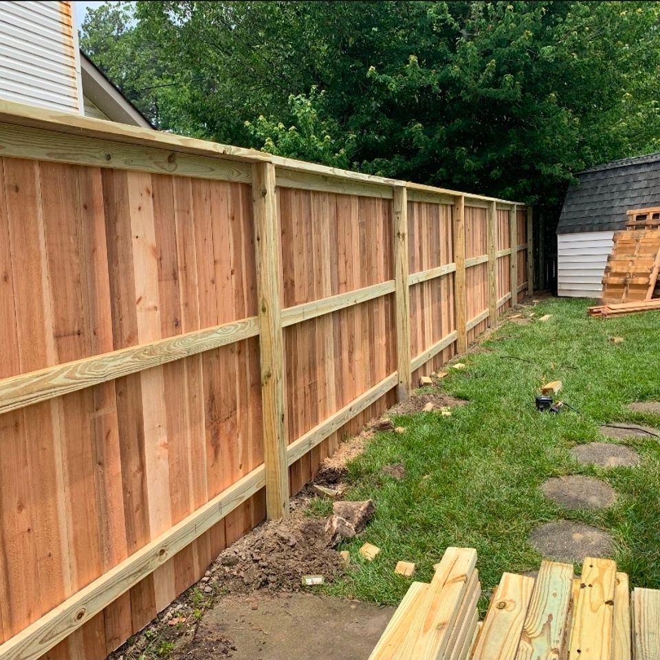 Cedar wood privacy fence with cap rail and trim installed along side yard in Virginia Beach VA