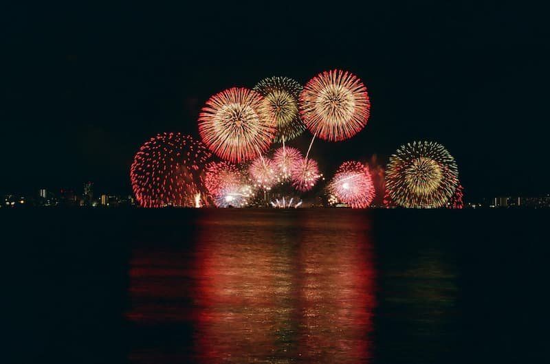 Fireworks over a body of water 