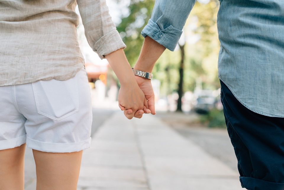 A couple holding hands going to therapy