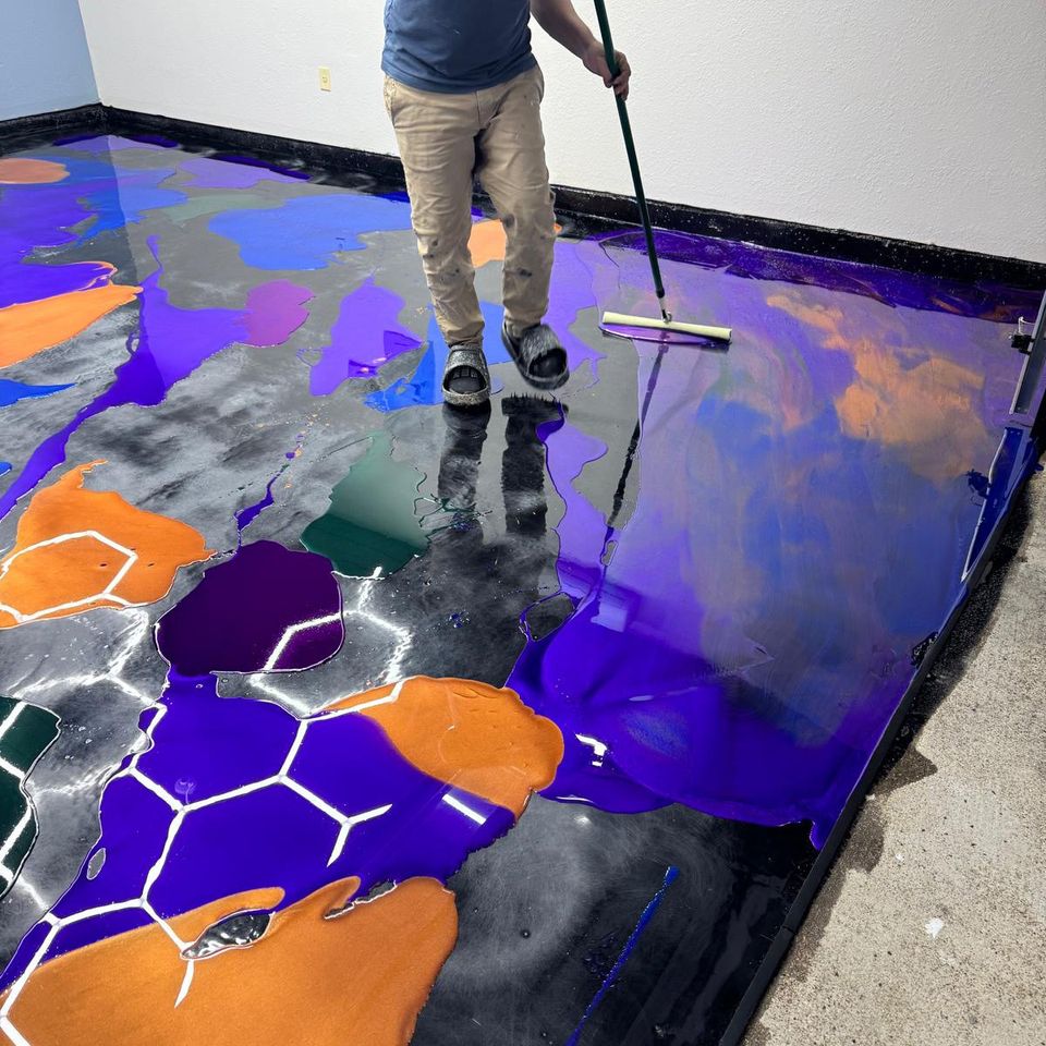 Professional installing metalic epoxy garage flooring