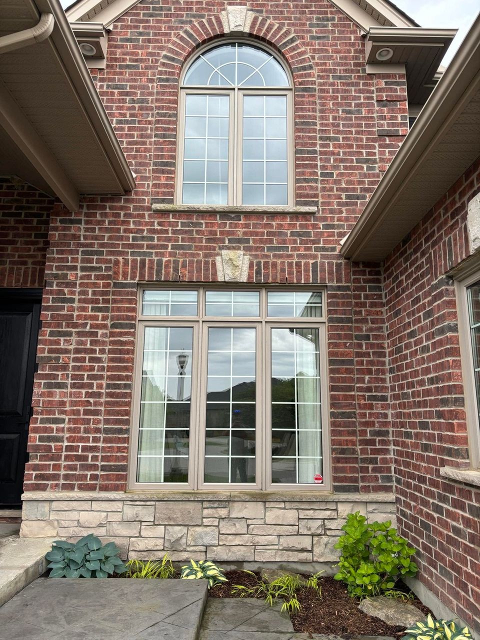 Streak-free windows on a brick home exterior after a professional window washing