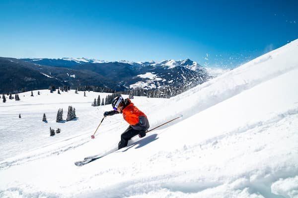 Skier downhill skiing a mild to medium incline 