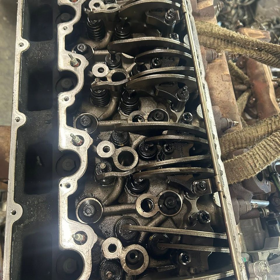 Diesel cylinder head with valves and rockers during engine teardown in Arab Alabama