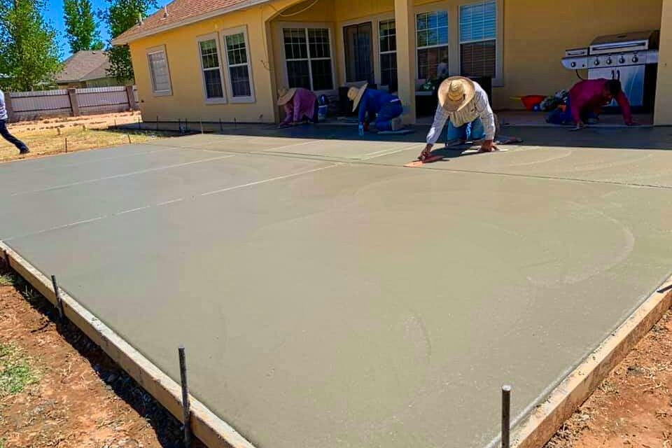 Skilled masonry professional hand-finishing a custom cement patio surface to ensure a smooth and level outdoor living space by Roseville Concrete Solutions.