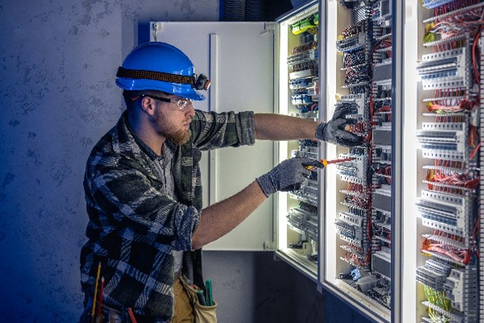 A male electrician works in a switchboard in overa 2025 01 07 17 11 07 utc