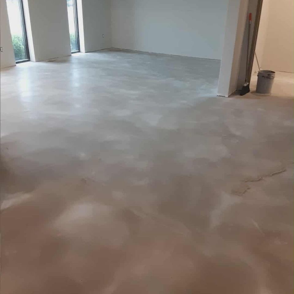 Interior space with a smooth, freshly prepared concrete floor.