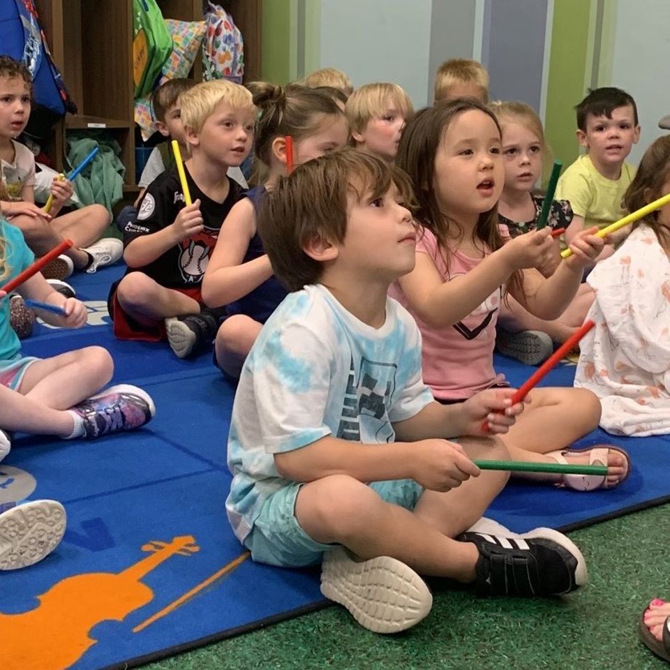 Kids playing rhythm sticks