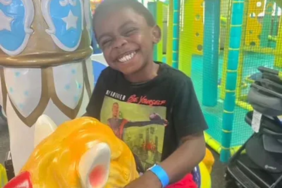 Child on a pony ride- mechanical ride at Chuck E. Cheese