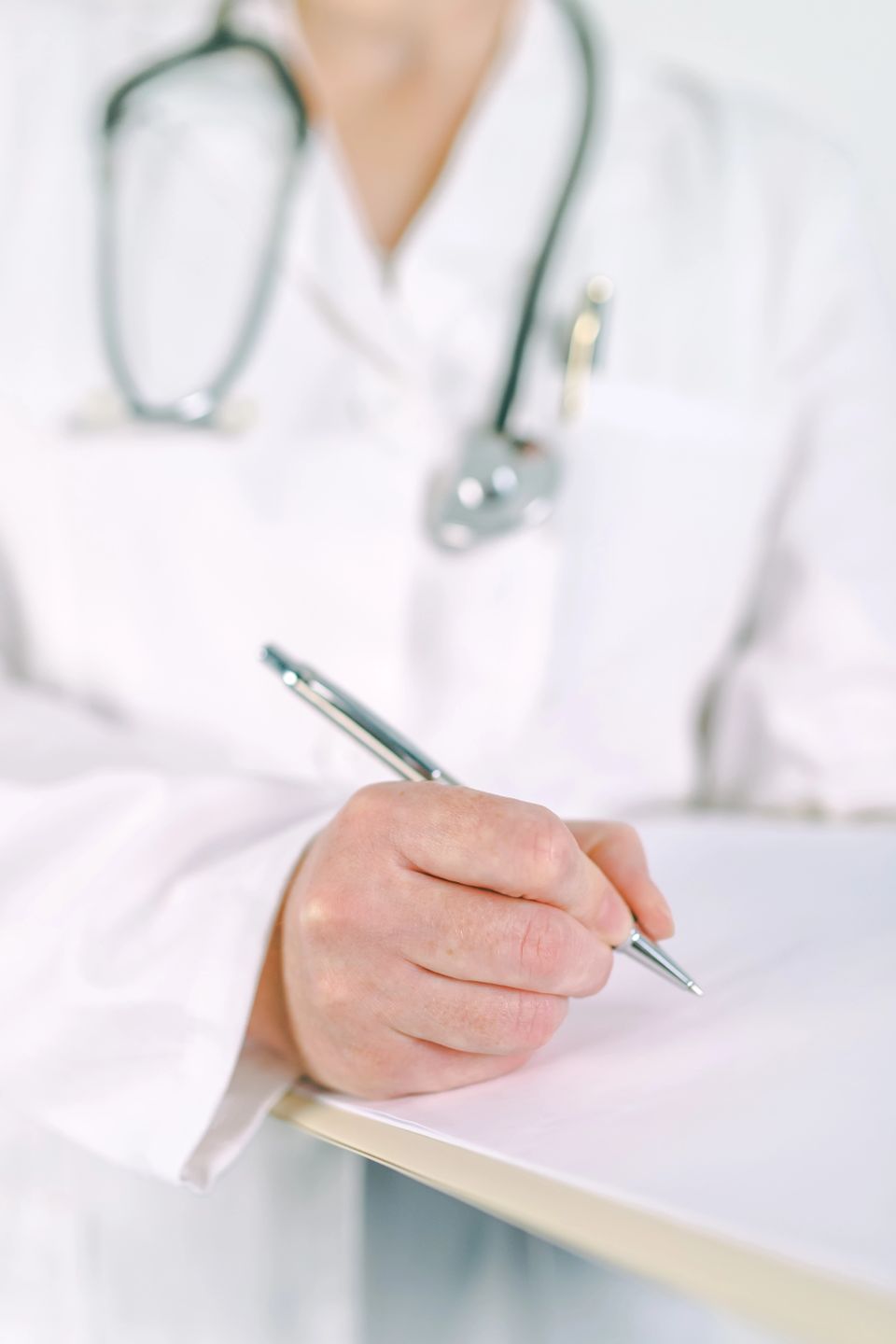 Vistacreate 129856272 stock photo female doctor in white uniform writing on clipboard paper