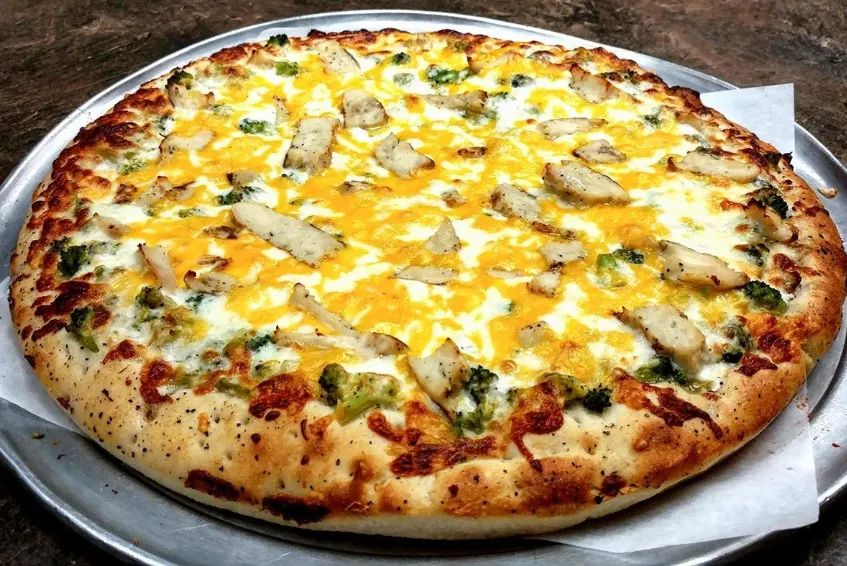 Pizza with melted cheese and savory toppings on a golden crust.