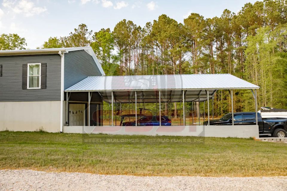 White steel carport attached to gray home covering vehicles with SBSI watermark representing steel carports in Alabama