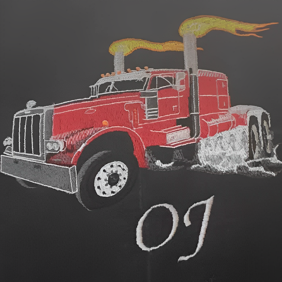 Close-up embroidery of a red semi-truck with custom stitched details and initials on a black garment.