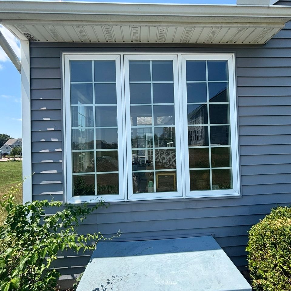 Bay window and gray siding on home exterior after window cleaning service in Harrisburg PA
